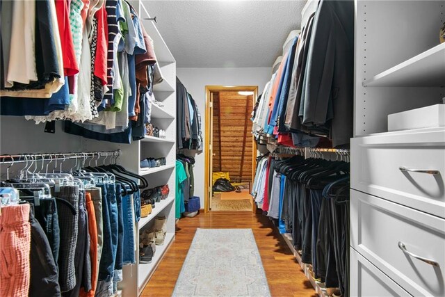 13008 Fontana St, Leawood, KS 66209 - walk in closet featuring wood finished floors