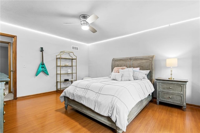13008 Fontana St, Leawood, KS 66209 - bedroom with wood finished floors, baseboards, and a ceiling fan