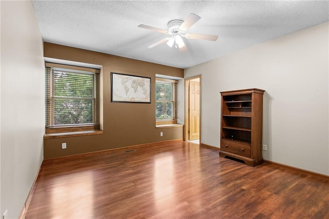 13008 Fontana St, Leawood, KS 66209 - spare room featuring wood finished floors, healthy amount of natural light, a ceiling fan, and a textured ceiling