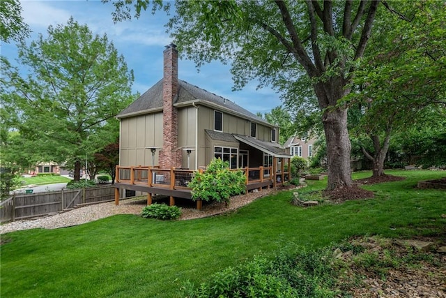13008 Fontana St, Leawood, KS 66209 - rear view of property featuring a deck, a chimney, board and batten siding, and roof with shingles
