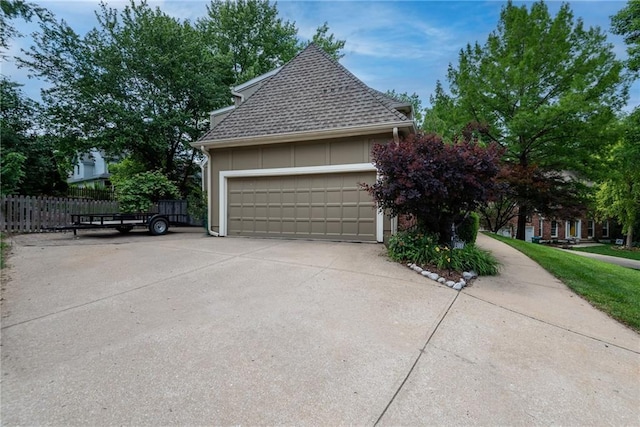 13008 Fontana St, Leawood, KS 66209 - view of home's exterior featuring a garage, driveway, and a shingled roof