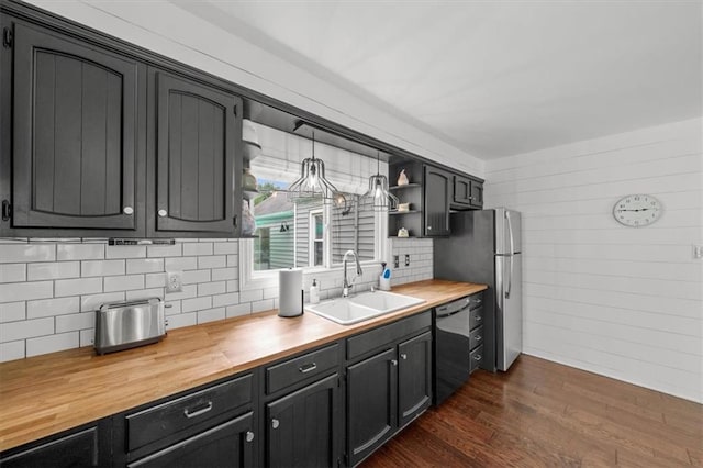 5741 Hadley St, Merriam, KS 66202 - kitchen with a sink, dishwashing machine, butcher block counters, dark wood-style floors, and tasteful backsplash