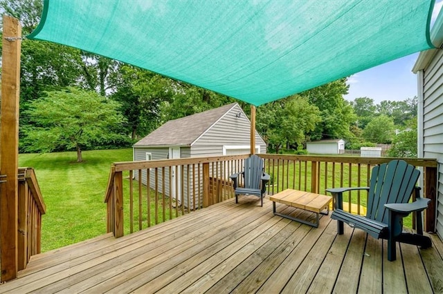 5741 Hadley St, Merriam, KS 66202 - deck featuring an outdoor structure, a lawn, and view of wooded area