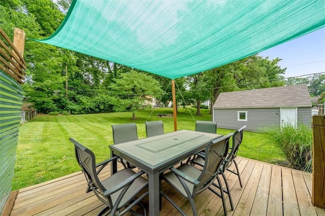 5741 Hadley St, Merriam, KS 66202 - wooden terrace with outdoor dining space, a lawn, an outdoor structure, and view of scattered trees