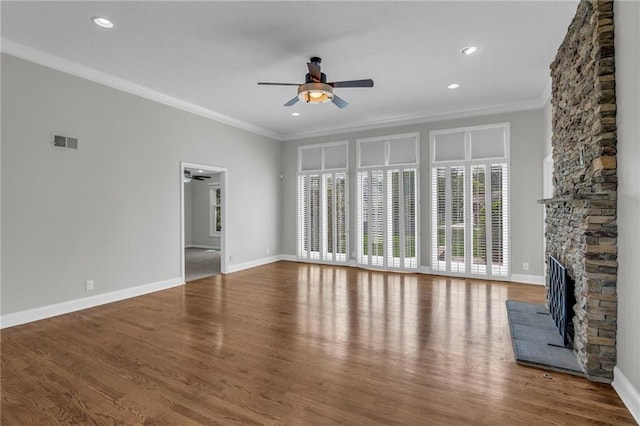 12428 Cambridge Cir, Leawood, KS 66209 - unfurnished living room featuring a ceiling fan, a stone fireplace, ornamental molding, wood finished floors, and recessed lighting