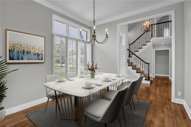 12428 Cambridge Cir, Leawood, KS 66209 - dining area featuring a chandelier, stairway, baseboards, dark wood finished floors, and ornamental molding