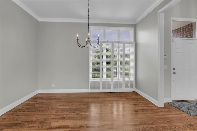 12428 Cambridge Cir, Leawood, KS 66209 - unfurnished dining area with a chandelier, wood finished floors, crown molding, and baseboards