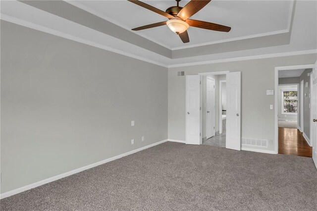 12428 Cambridge Cir, Leawood, KS 66209 - unfurnished bedroom with a raised ceiling, carpet flooring, ornamental molding, baseboards, and a ceiling fan