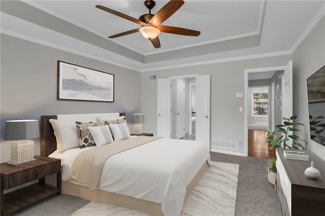 12428 Cambridge Cir, Leawood, KS 66209 - carpeted bedroom with a tray ceiling, crown molding, baseboards, and ceiling fan