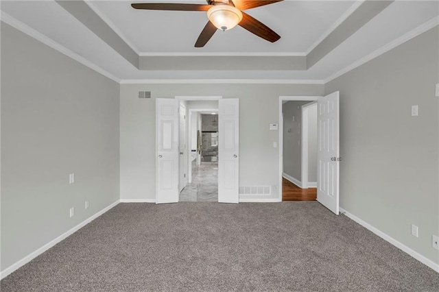 12428 Cambridge Cir, Leawood, KS 66209 - unfurnished bedroom with carpet flooring, a tray ceiling, baseboards, and crown molding