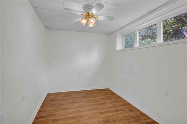 12428 Cambridge Cir, Leawood, KS 66209 - spare room featuring light wood-style floors, a ceiling fan, and baseboards