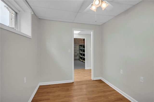 12428 Cambridge Cir, Leawood, KS 66209 - spare room with ceiling fan, wood finished floors, baseboards, and a fireplace