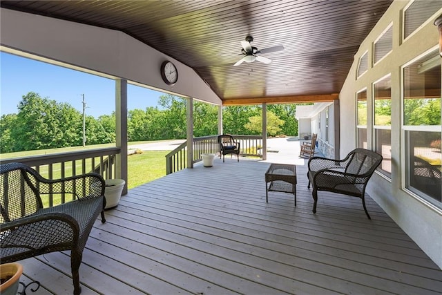 3906 Oo Hwy, Odessa, MO 64076 - wooden deck featuring a ceiling fan, view of wooded area, and a yard