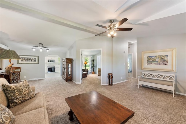 3906 Oo Hwy, Odessa, MO 64076 - living area featuring lofted ceiling, carpet, ceiling fan, a fireplace, and baseboards