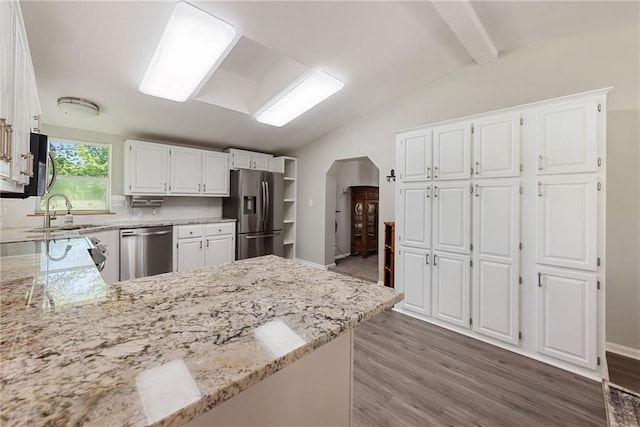 3906 Oo Hwy, Odessa, MO 64076 - kitchen featuring stainless steel appliances, light stone countertops, wood finished floors, white cabinetry, and a sink