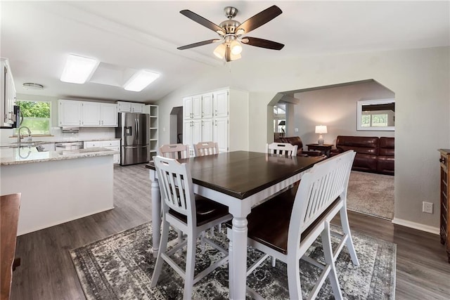 3906 Oo Hwy, Odessa, MO 64076 - dining space with a ceiling fan, arched walkways, wood finished floors, lofted ceiling, and baseboards