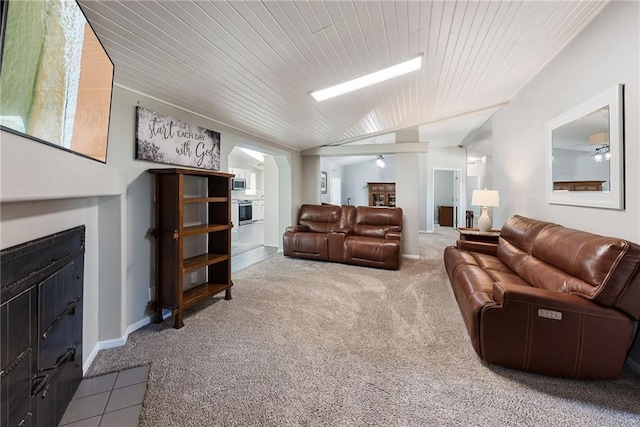 3906 Oo Hwy, Odessa, MO 64076 - living area featuring carpet floors, a fireplace with flush hearth, wooden ceiling, arched walkways, and lofted ceiling