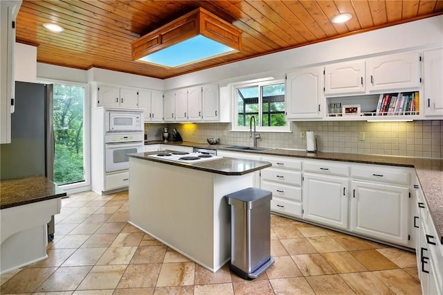 12844 Granada Ln, Leawood, KS 66209 - kitchen featuring white appliances, wooden ceiling, backsplash, white cabinetry, and recessed lighting