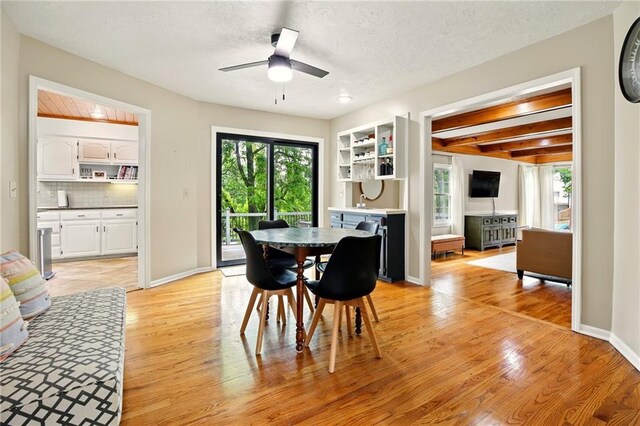 12844 Granada Ln, Leawood, KS 66209 - dining area featuring plenty of natural light, light wood-style flooring, ceiling fan, a textured ceiling, and beamed ceiling
