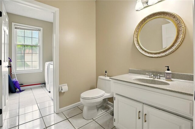 12844 Granada Ln, Leawood, KS 66209 - bathroom with washer / clothes dryer, vanity, and tile patterned flooring