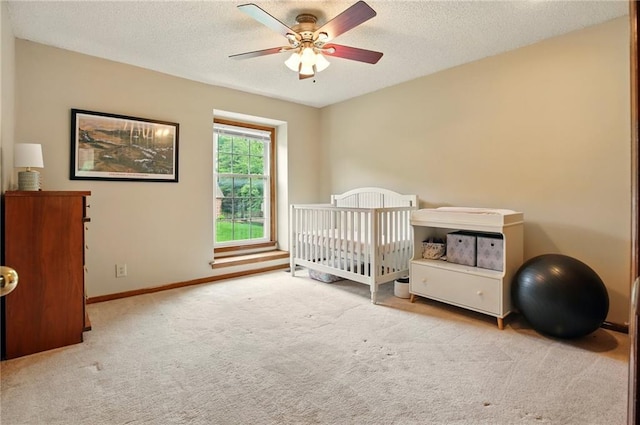12844 Granada Ln, Leawood, KS 66209 - carpeted bedroom featuring a textured ceiling, a ceiling fan, and a nursery area