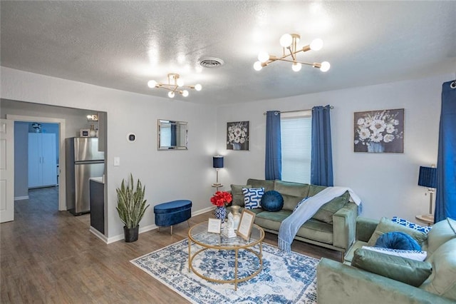 3802 Roanoke Rd, Kansas City, MO 64111 - living area featuring a chandelier, wood finished floors, baseboards, and a textured ceiling