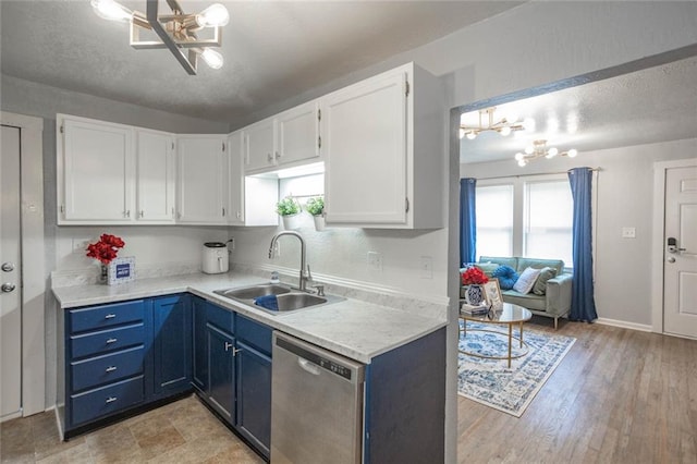 3802 Roanoke Rd, Kansas City, MO 64111 - kitchen with dishwasher, a sink, a chandelier, white cabinetry, and a textured ceiling