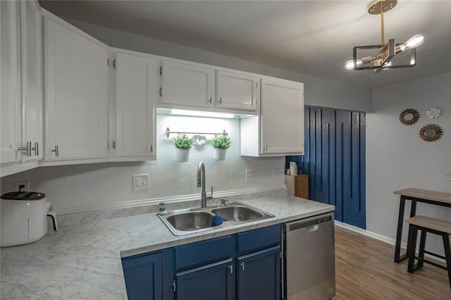 3802 Roanoke Rd, Kansas City, MO 64111 - kitchen with blue cabinets, stainless steel dishwasher, a sink, and light countertops
