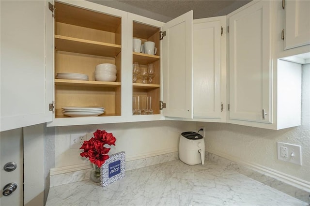 3802 Roanoke Rd, Kansas City, MO 64111 - kitchen view of white cabinetry and baseboards
