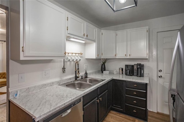 3802 Roanoke Rd, Kansas City, MO 64111 - kitchen featuring a sink, appliances with stainless steel finishes, white cabinetry, and light countertops
