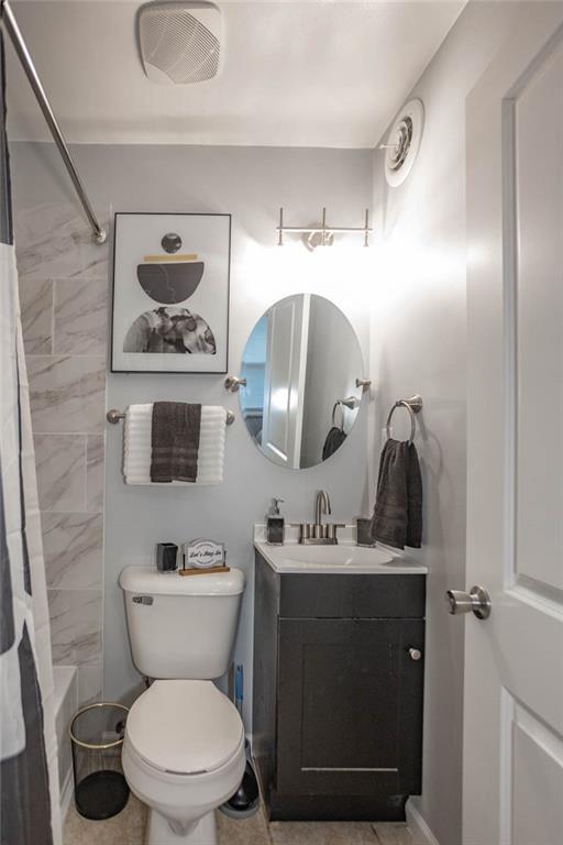 3802 Roanoke Rd, Kansas City, MO 64111 - bathroom featuring vanity, toilet, shower / tub combo, and baseboards