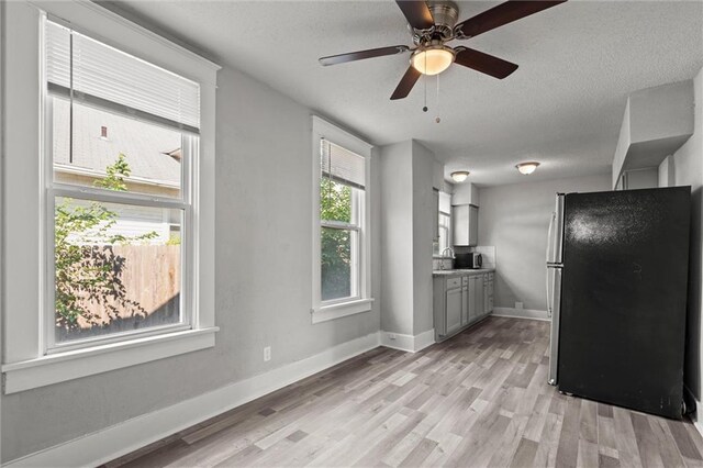 509 Pottawatomie St, Leavenworth, KS 66048 - kitchen with freestanding refrigerator, gray cabinetry, a textured ceiling, light wood-style floors, and ceiling fan