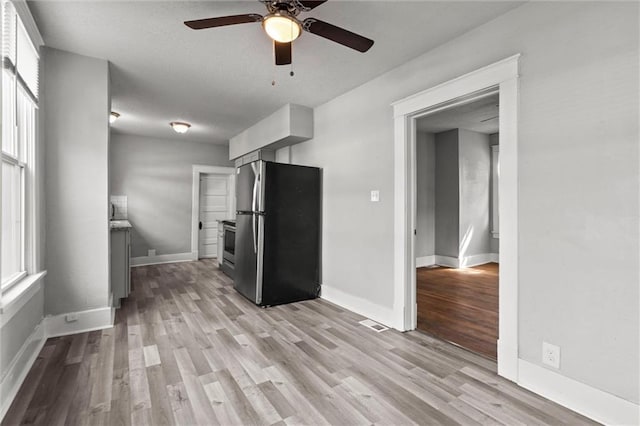 509 Pottawatomie St, Leavenworth, KS 66048 - kitchen with appliances with stainless steel finishes, a ceiling fan, light wood finished floors, and gray cabinetry