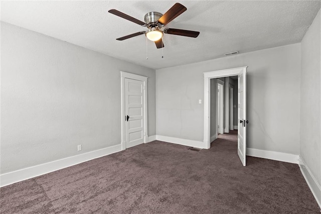 509 Pottawatomie St, Leavenworth, KS 66048 - unfurnished bedroom with dark colored carpet, a textured ceiling, and ceiling fan