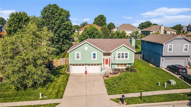 212 Hampton Dr, Smithville, MO 64089 - raised ranch with a garage, concrete driveway, and a residential view