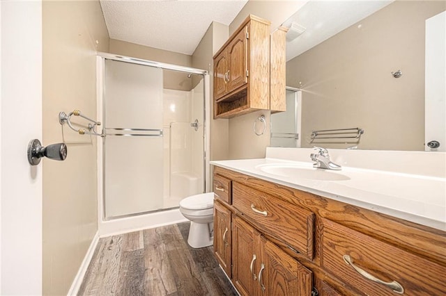 212 Hampton Dr, Smithville, MO 64089 - full bathroom featuring a shower stall, wood finished floors, vanity, and a textured ceiling