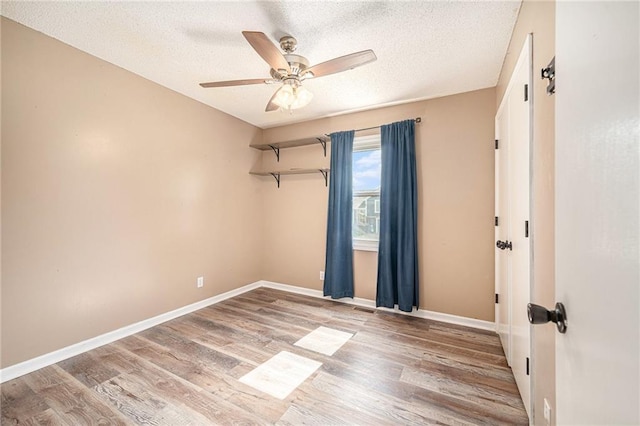 212 Hampton Dr, Smithville, MO 64089 - unfurnished room with ceiling fan, wood finished floors, and a textured ceiling