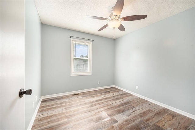 212 Hampton Dr, Smithville, MO 64089 - spare room featuring a ceiling fan, wood finished floors, and a textured ceiling