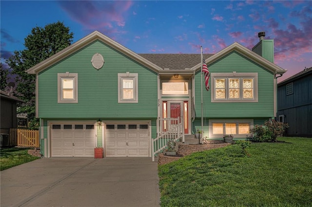 212 Hampton Dr, Smithville, MO 64089 - bi-level home with an attached garage, concrete driveway, and a chimney