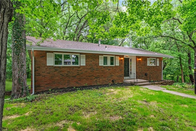 804 5th St, Baldwin City, KS 66006 - ranch-style house with brick siding and a front yard