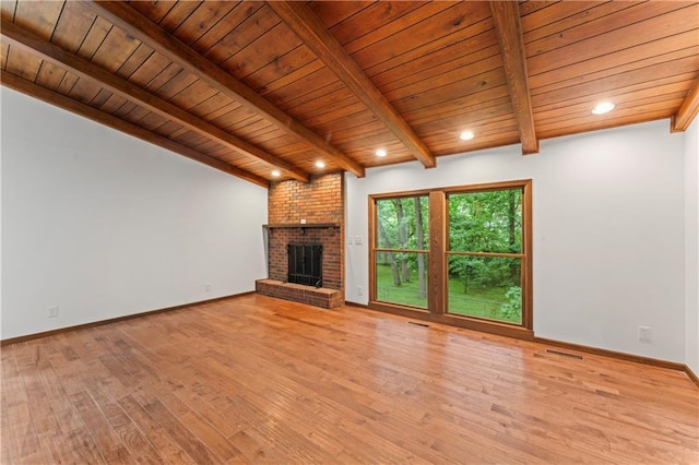 804 5th St, Baldwin City, KS 66006 - unfurnished living room featuring wood ceiling with exposed beams, light wood finished floors, a fireplace, baseboards, and recessed lighting