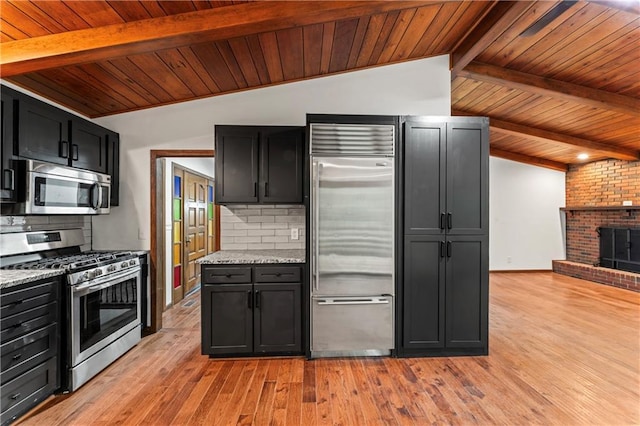 804 5th St, Baldwin City, KS 66006 - kitchen with appliances with stainless steel finishes, tasteful backsplash, wooden ceiling, light stone counters, and light wood-style flooring