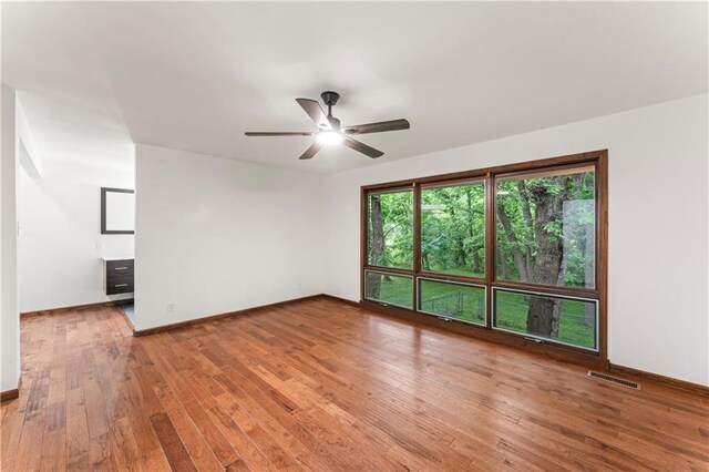 804 5th St, Baldwin City, KS 66006 - spare room with ceiling fan, wood-type flooring, and baseboards