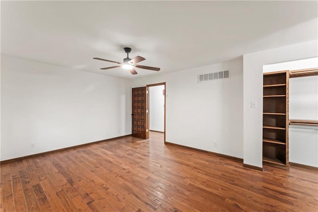 804 5th St, Baldwin City, KS 66006 - unfurnished bedroom with baseboards, wood finished floors, and a ceiling fan