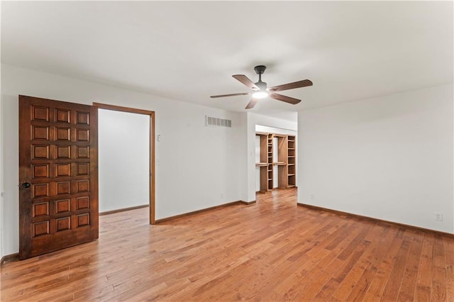 804 5th St, Baldwin City, KS 66006 - spare room with a ceiling fan, light wood-style flooring, and baseboards