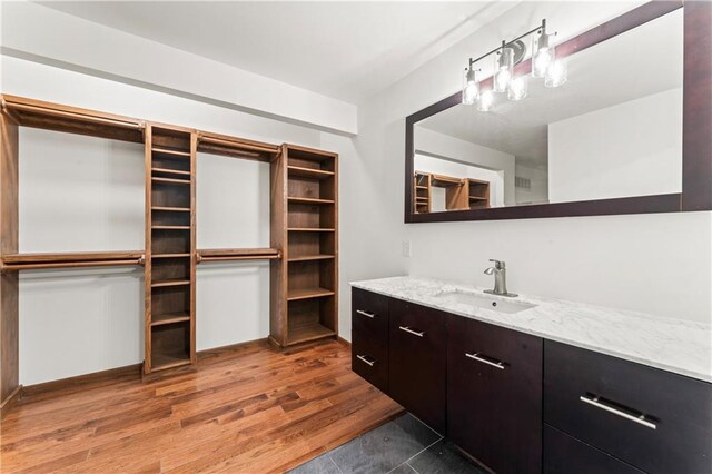 804 5th St, Baldwin City, KS 66006 - bathroom featuring wood finished floors and vanity