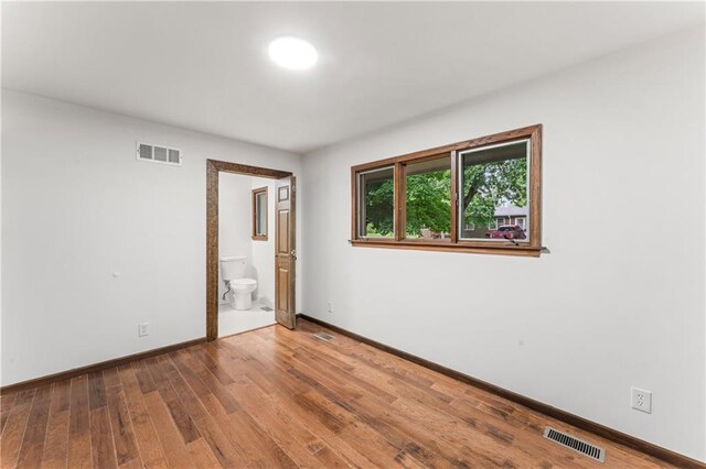 804 5th St, Baldwin City, KS 66006 - unfurnished room with baseboards and wood finished floors