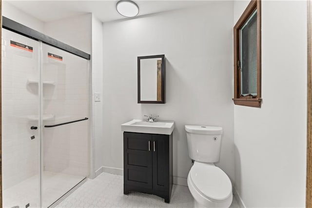 804 5th St, Baldwin City, KS 66006 - full bath with toilet, vanity, a shower stall, baseboards, and tile patterned floors