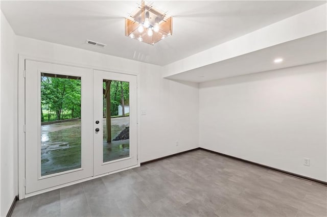 804 5th St, Baldwin City, KS 66006 - unfurnished room featuring french doors, a chandelier, and baseboards