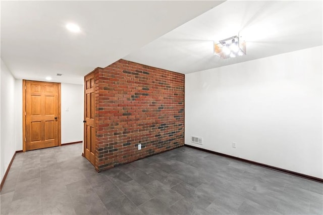 804 5th St, Baldwin City, KS 66006 - empty room featuring brick wall, baseboards, and recessed lighting